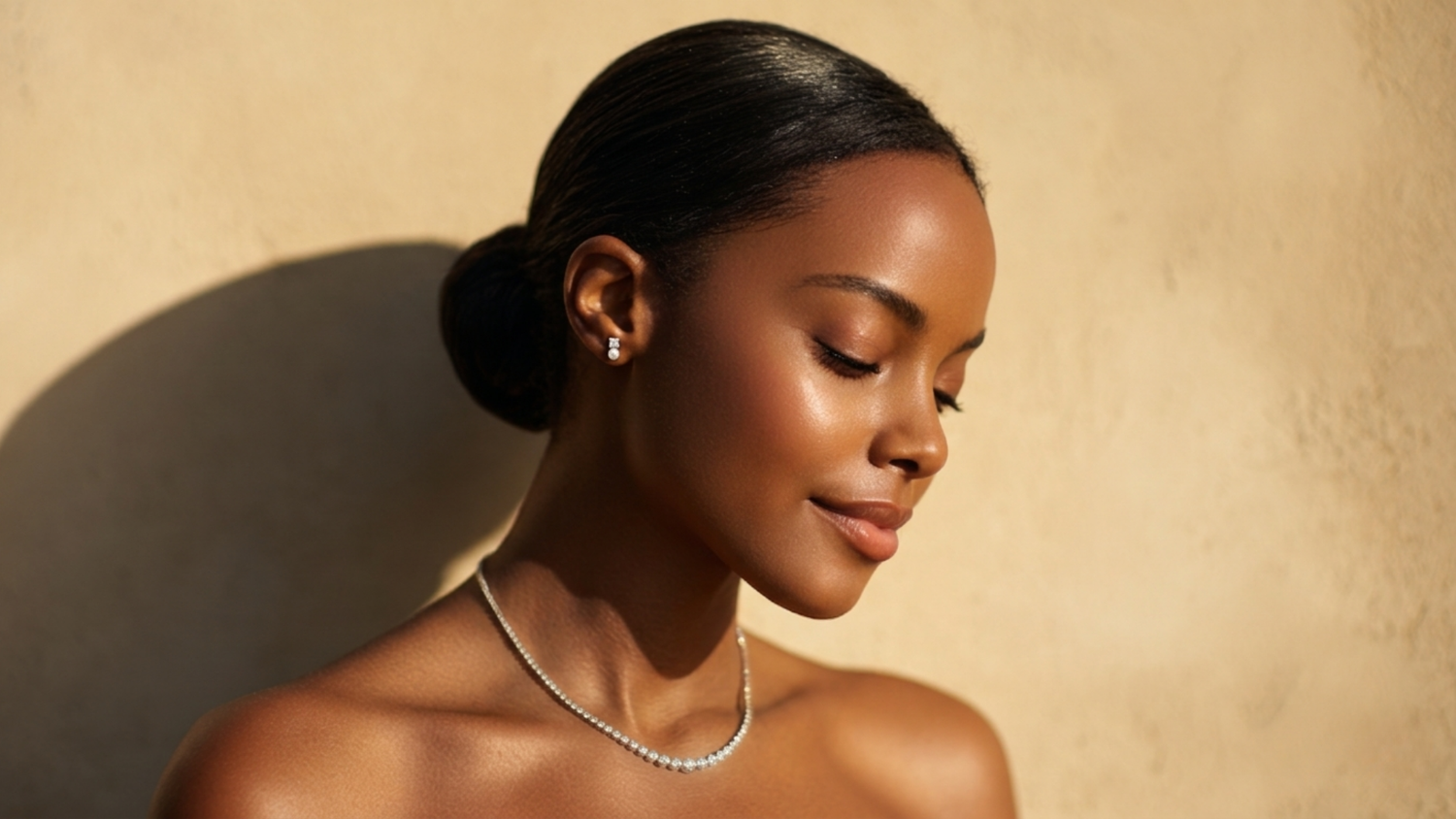A women wearing Pas de Deux's Perle earrings and diamond Atomic necklace